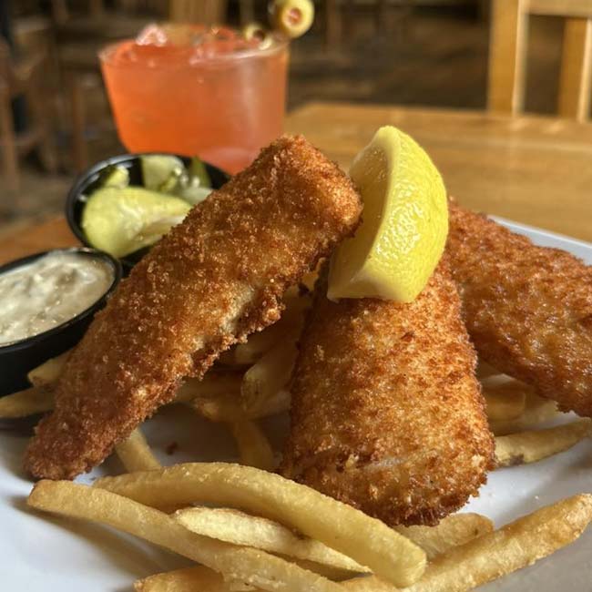Three breaded fish fillets with fries and sauce at The Depot, a classic Green Bay family restaurant.
