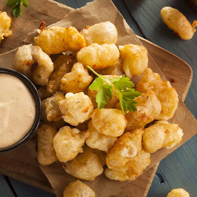 Golden fried cheese curds at the bar, served with dipping sauce—a Green Bay classic snack.